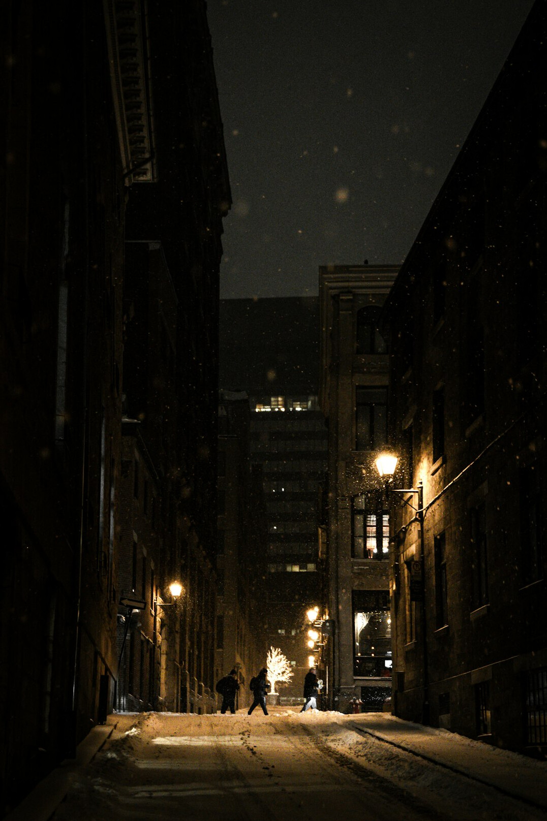 person walking on city street at night
